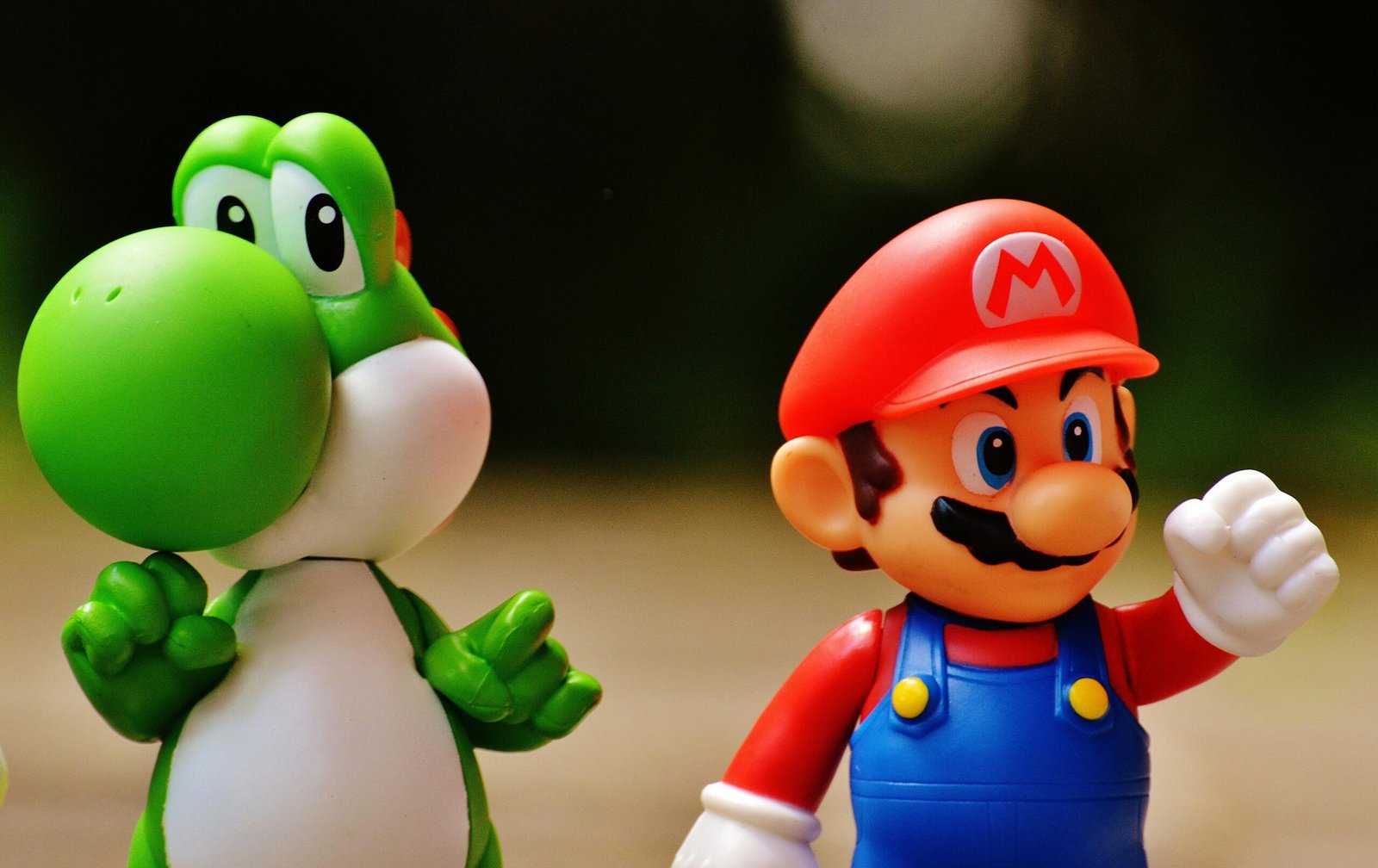 Detailed close-up of Mario and Yoshi figurines from a popular video game franchise.